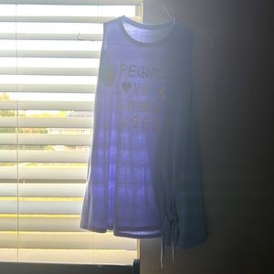 I am selling a long purple flowy shirt that says peace love and good vibes!